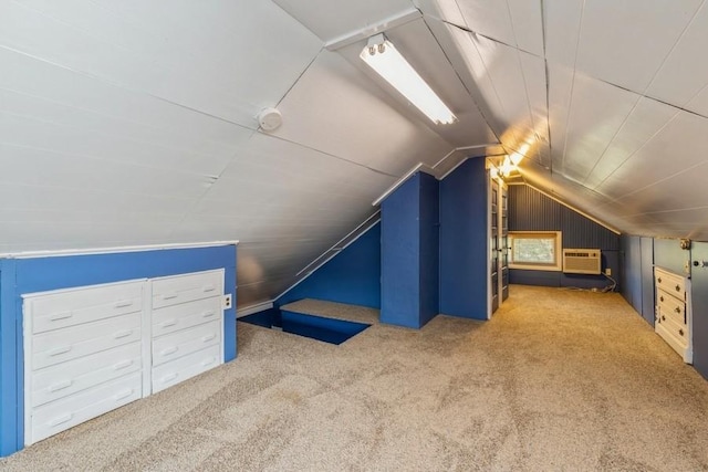 additional living space with vaulted ceiling, carpet, wood walls, and a wall mounted AC