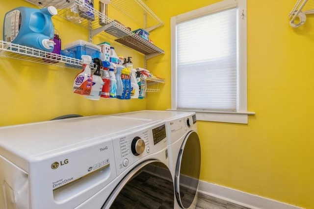 laundry area featuring laundry area, baseboards, and washing machine and clothes dryer