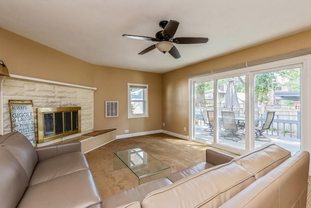 unfurnished living room featuring visible vents, ceiling fan, a fireplace, and baseboards