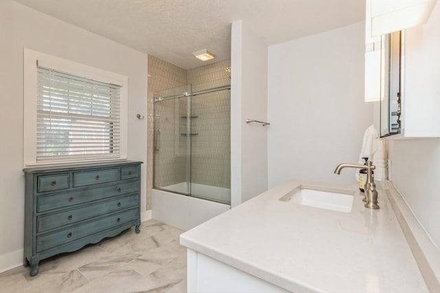 full bathroom featuring vanity, marble finish floor, and enclosed tub / shower combo