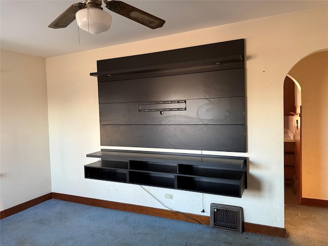 interior details with arched walkways, baseboards, carpet, and a ceiling fan