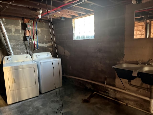 basement with a sink and washing machine and dryer