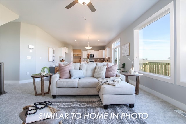 living area featuring recessed lighting, visible vents, light colored carpet, and baseboards