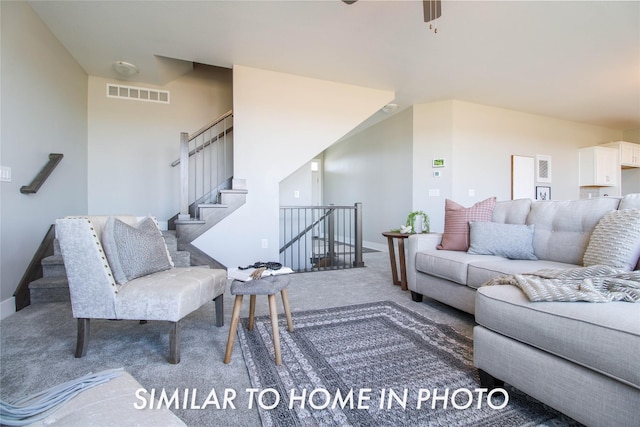 living area featuring stairway, carpet flooring, baseboards, and visible vents