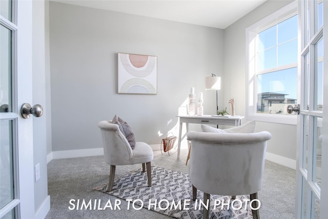 carpeted office space featuring french doors and baseboards