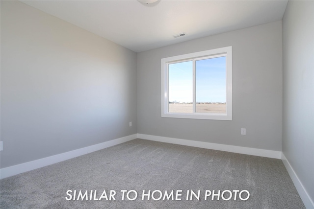 carpeted empty room with visible vents and baseboards