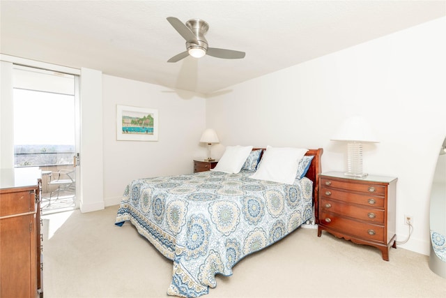 bedroom featuring ceiling fan, baseboards, and light carpet