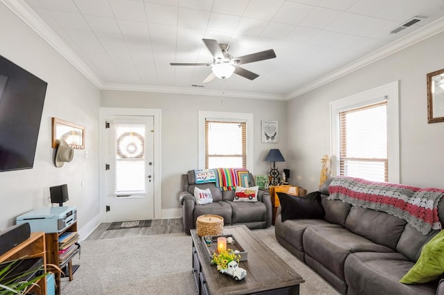 living room with visible vents, crown molding, baseboards, ceiling fan, and wood finished floors