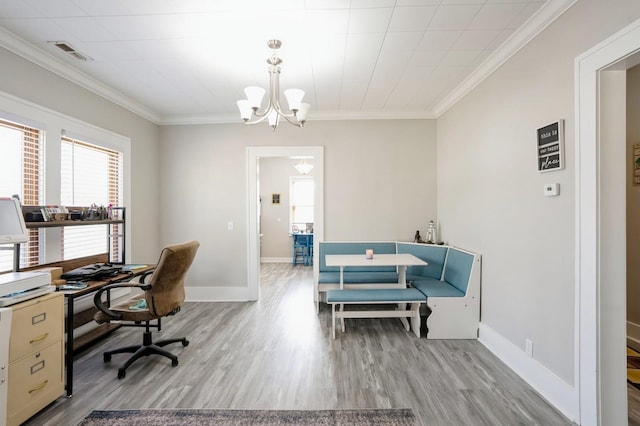 office area with crown molding, wood finished floors, visible vents, and baseboards