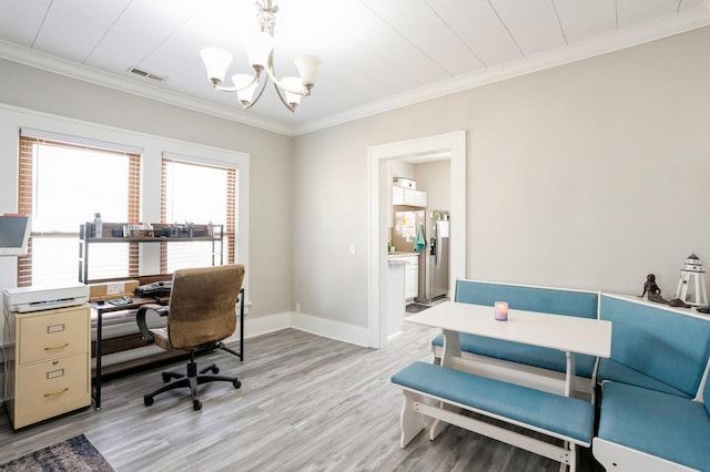 office space with light wood-type flooring, baseboards, ornamental molding, and a chandelier