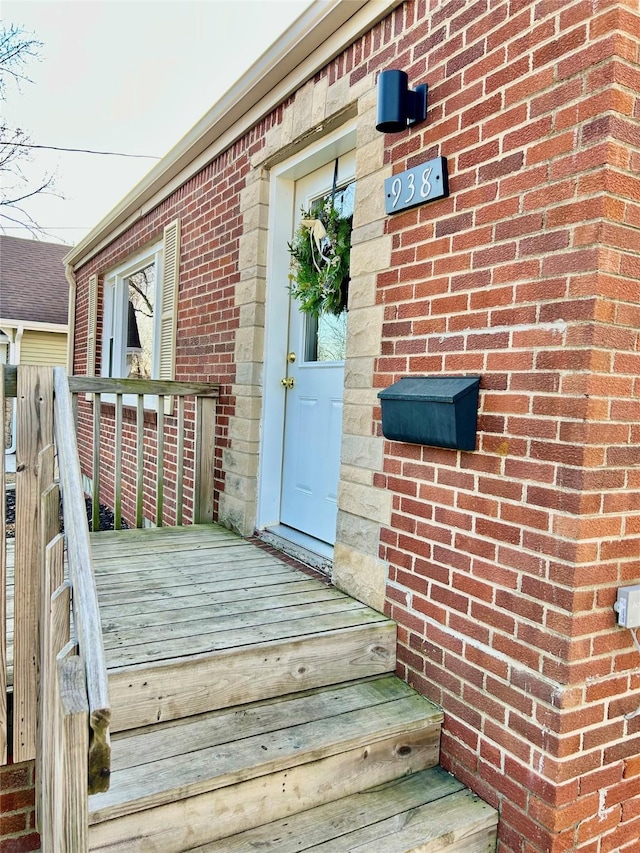 view of exterior entry with brick siding