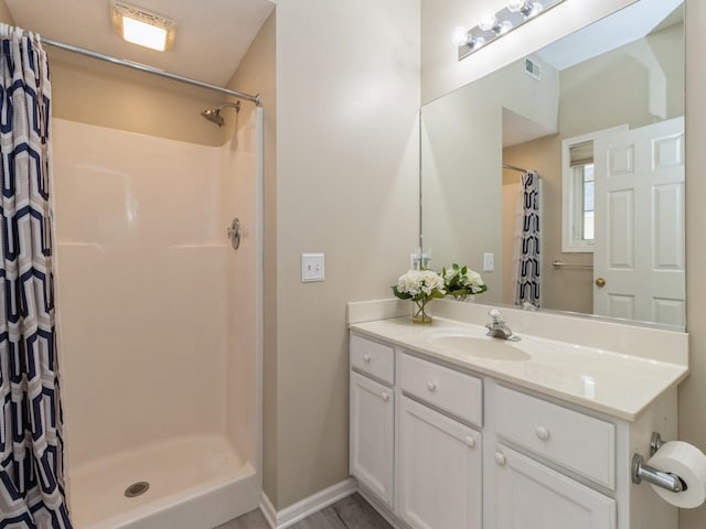 bathroom with baseboards, visible vents, vanity, and a shower with curtain