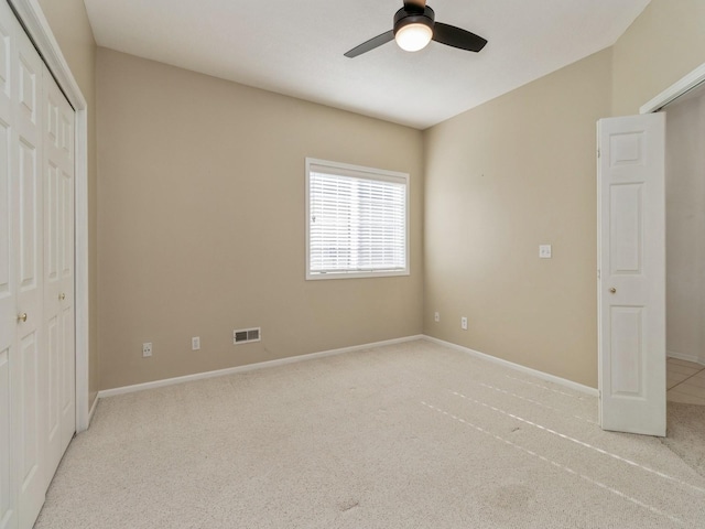 unfurnished bedroom featuring visible vents, baseboards, and carpet flooring