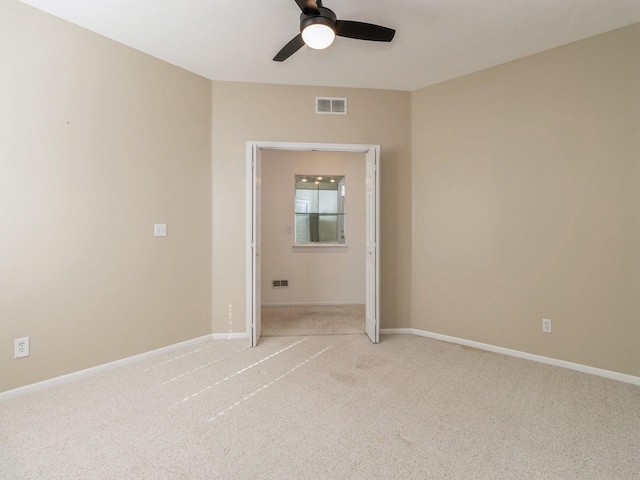 unfurnished room featuring visible vents, baseboards, and light colored carpet