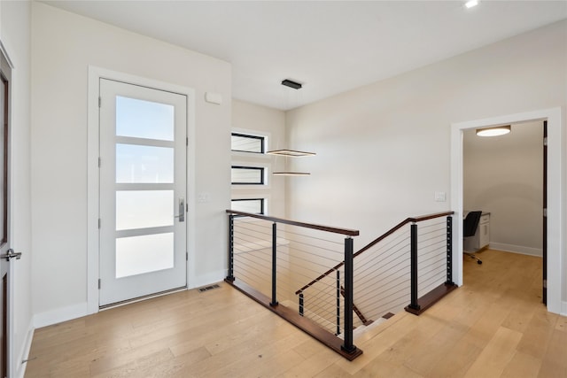 foyer featuring baseboards and light wood-style floors