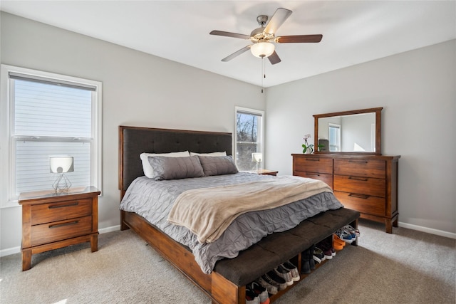 bedroom with ceiling fan, baseboards, and light carpet