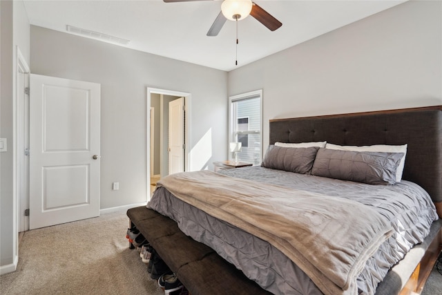 bedroom with visible vents, connected bathroom, carpet flooring, baseboards, and ceiling fan