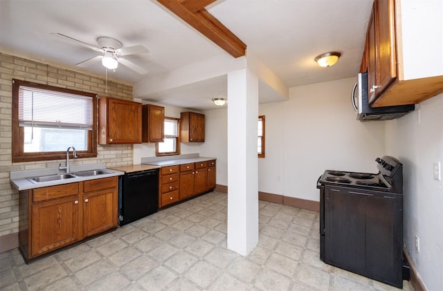 kitchen with light floors, light countertops, brown cabinetry, black appliances, and a sink