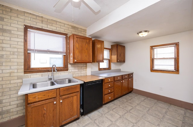 kitchen featuring light countertops, black dishwasher, light floors, and a sink