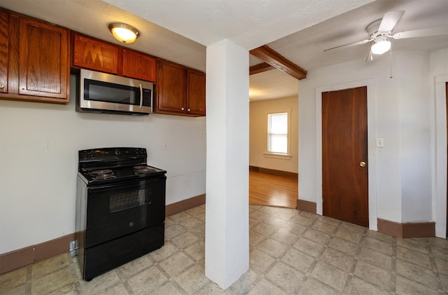 kitchen featuring stainless steel microwave, baseboards, light floors, black electric range, and brown cabinetry