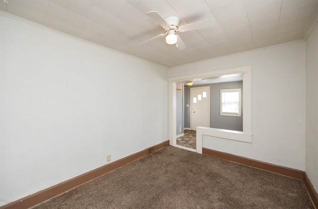 unfurnished room with ornamental molding, carpet flooring, baseboards, and ceiling fan