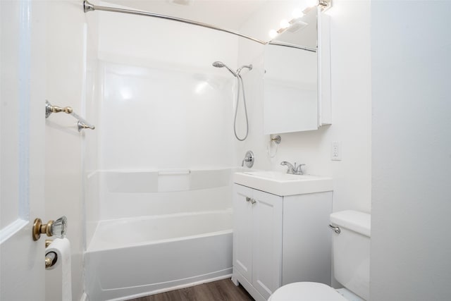 full bath with vanity, toilet, shower / tub combination, and wood finished floors