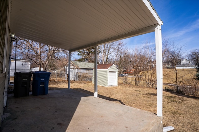 view of patio / terrace featuring an outbuilding, a storage unit, and fence