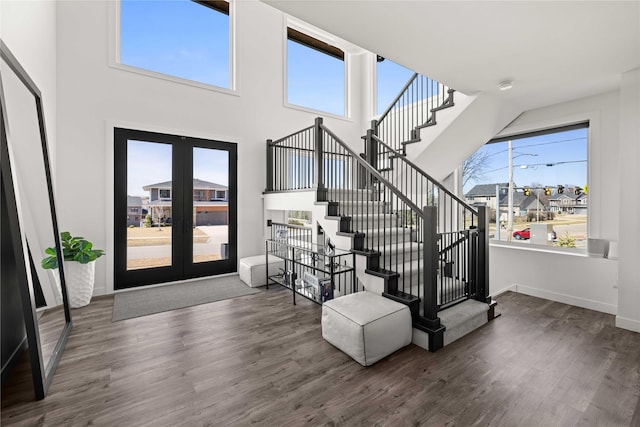 foyer featuring a wealth of natural light, french doors, baseboards, and wood finished floors