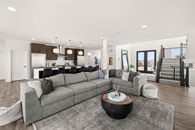 living room with recessed lighting, stairs, and wood finished floors