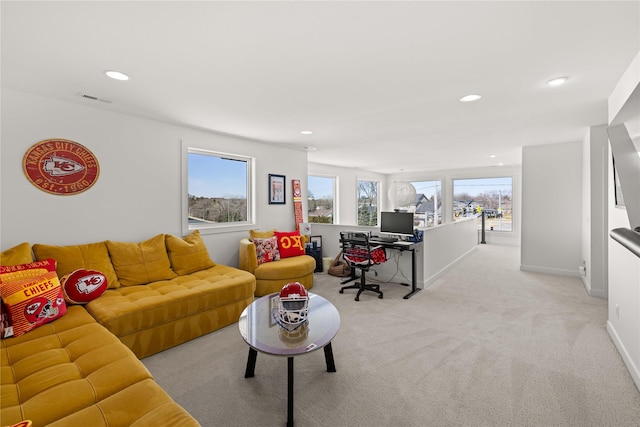 living area featuring recessed lighting, visible vents, plenty of natural light, and light carpet