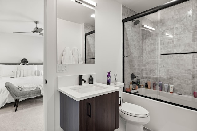 full bathroom with vanity, enclosed tub / shower combo, ensuite bath, ceiling fan, and toilet