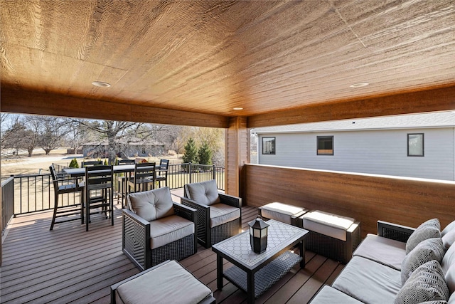 wooden terrace with an outdoor hangout area