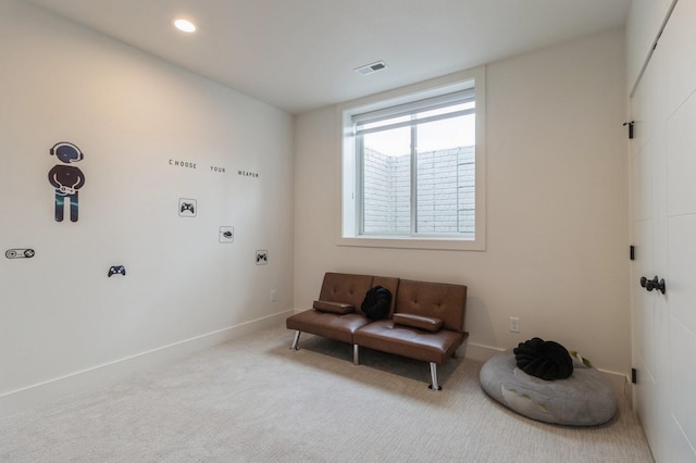 sitting room featuring baseboards, visible vents, and carpet floors