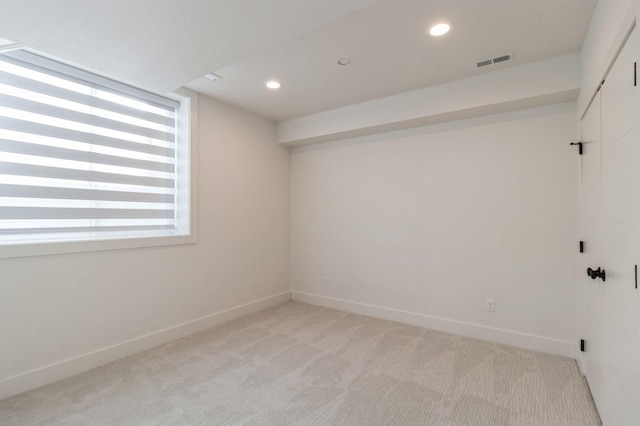 unfurnished room featuring recessed lighting, visible vents, light colored carpet, and baseboards