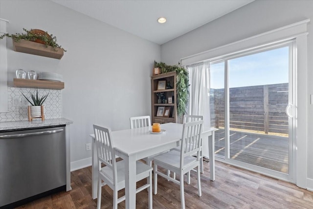 dining space with recessed lighting, baseboards, and wood finished floors