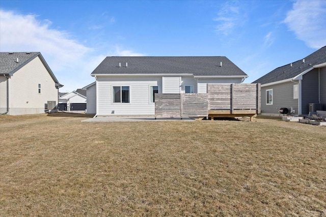 back of property featuring a patio area, a lawn, and central AC