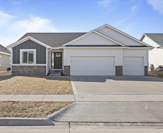 view of front of home featuring stone siding, board and batten siding, concrete driveway, and an attached garage