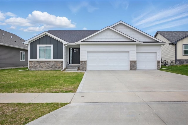 view of front of home featuring a front yard, an attached garage, stone siding, and driveway