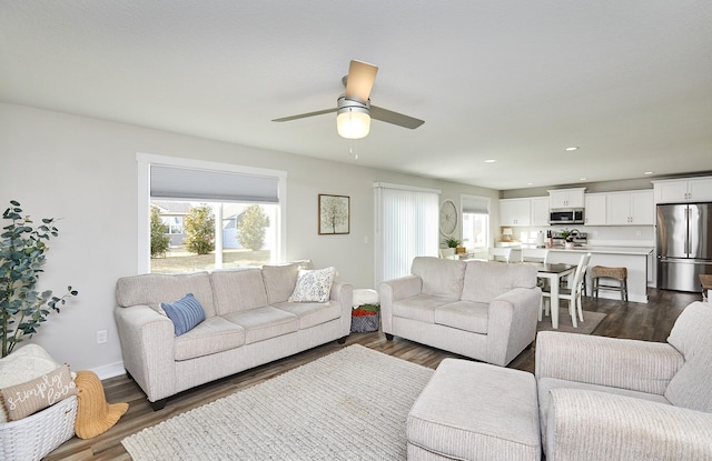 living room featuring a ceiling fan, recessed lighting, dark wood-style flooring, and baseboards