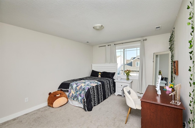 carpeted bedroom with visible vents, baseboards, and a textured ceiling