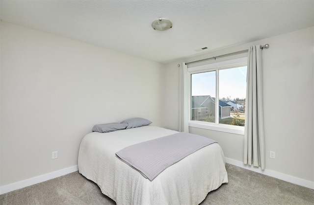 bedroom featuring visible vents, baseboards, and carpet floors