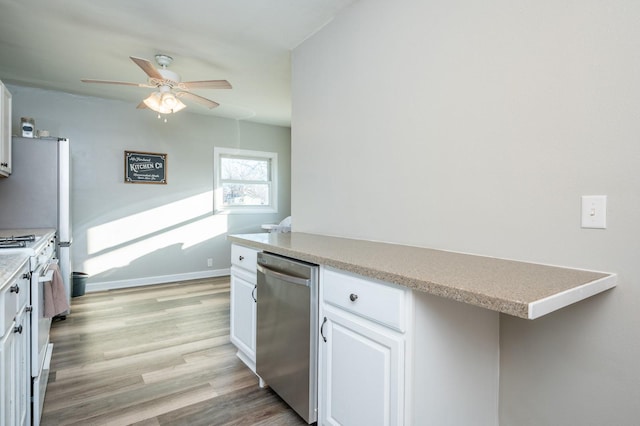 kitchen with ceiling fan, light countertops, light wood-style flooring, white cabinets, and white appliances