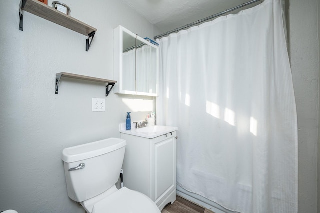 full bathroom featuring vanity, toilet, and wood finished floors