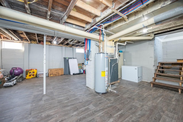 basement with stairs, gas water heater, and wood finished floors