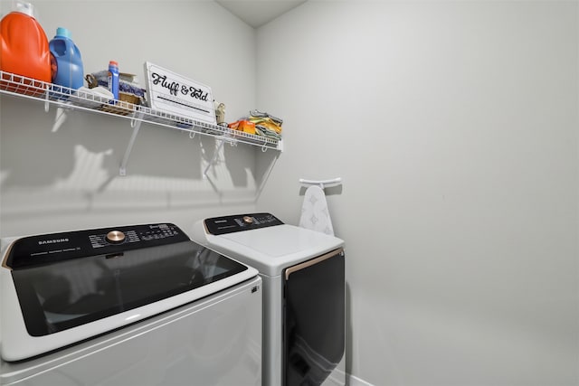 clothes washing area with laundry area and washer and clothes dryer