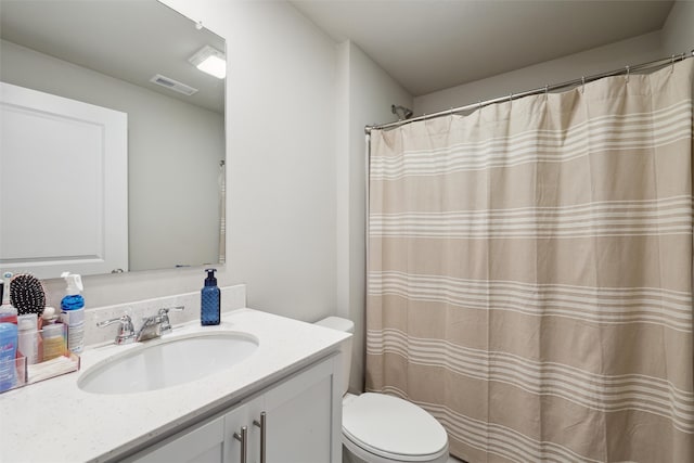 full bathroom featuring visible vents, toilet, and vanity