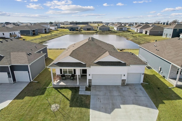 birds eye view of property featuring a residential view and a water view