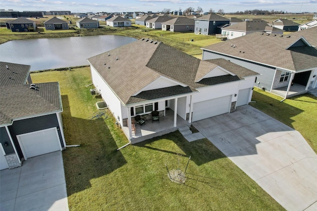 birds eye view of property with a residential view and a water view