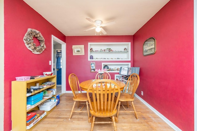 dining room featuring a ceiling fan, wood finished floors, and baseboards