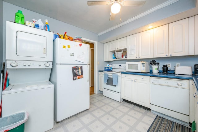 kitchen featuring white appliances, light floors, ornamental molding, white cabinets, and stacked washer and clothes dryer